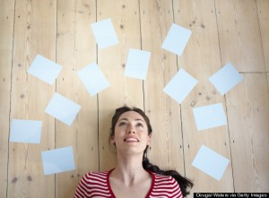 Woman surrounded by blank sheets of paper