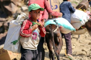 A Yemeni boy carries a bag of food as he walks through the mountains along the only path accessible between the southern cities of Aden and Taez on December 26, 2015, since the main roads leading to the embattled city of Taez are blocked due to the ongoing fighting between forces loyal to Yemen's Saudi-backed President Abedrabbo Mansour Hadi and Shiite Huthi rebels. AFP PHOTO / AHMAD AL-BASHA / AFP / AHMAD AL-BASHA (Photo credit should read AHMAD AL-BASHA/AFP/Getty Images)