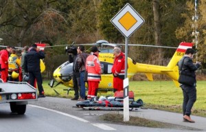 Rescuers and journalists stand in front of a rescue helicopter near Bad Aibling in southwestern Germany, February 9, 2016. REUTERS/Michael Dalder