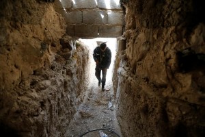 A fighter from the Iraqi Shi'ite Badr Organization holds his rifle in an underground tunnel built by Islamic State fighters on the outskirts of Falluja