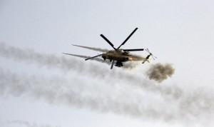 A helicopter fires weapons during clashes with Islamic State militants in Saqlawiya