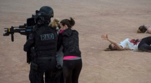 epa05350826 A wounded'victim' (R) gestures to police (L) as they secure the area where firefighters and emergency medical personnel take part in an anti-terrorism exercise at the Fan Zone in Place Bellecour, Lyon, France, 07 June 2016. Several hundred people, including volunteers, took part in the drill. EPA/CJ GUNTHER