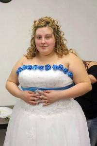 PIC FROM CATERS NEWS - (PICTURED: Lyndsey Hoover, 23, from Texas, USA before her weight loss on her wedding day.) - A young woman who was addicted to cheese burgers has lost a whopping 14 stone after ditching the bad habit and has spent 11k to perfect her dream body. Lyndsey Hoover, 23, from Texas, USA, weighed a whopping 23st and wore a dress size 30 after binging on burgers and three litres of diet coke every day.The beautiful brunette has lost a staggering 14st and dropped 15 dress sizes but was so unhappy with her excess skin that she paid for cosmetic surgery. After years of torment from her peers, Lyndsey underwent a gastric bypass and swapped her 4,000 calorie a day diet for a mere 700 calories - trading Big Macs and fried chicken for protein bars and salads. But due to her drastic weight loss, the mum of one to three year old Aiden, was left with severe excess skin and was forced to buy jeans two sizes too big in order to fit her saggy skin inside. Left with no other choice Lyndsey made the decision to have a tummy tuck, where surgeons removed 9lbs of excess skin, and to complete her transformation Lyndsey had a breast lift and implants. SEE CATERS COPY.