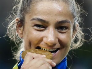 Kosovo's Majlinda Kelmendi celebrates withe the gold medal after winning the women's 52-kg judo competition at the 2016 Summer Olympics in Rio de Janeiro, Brazil, Sunday, Aug. 7, 2016. (AP Photo/Markus Schreiber)