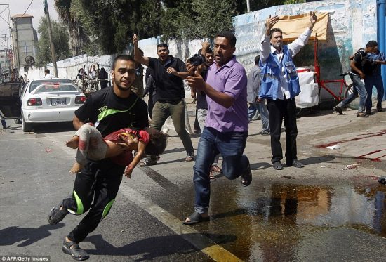 1407060285963_wps_29_A_Palestinian_man_carries