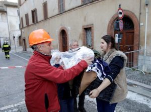 A woman carries her belongings after an earthquake in Visso, central Italy, October 27, 2016. REUTERS/Max Rossi