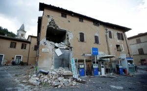 A collapsed building is seen next to a petrol station after an earthquake in Visso, central Italy, October 27, 2016. REUTERS/Max Rossi