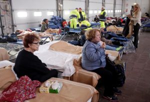 People take a rest after an earthquake in central Italy in a hangar used for recovery in Camerino, Italy October 27, 2016. REUTERS/Max Rossi