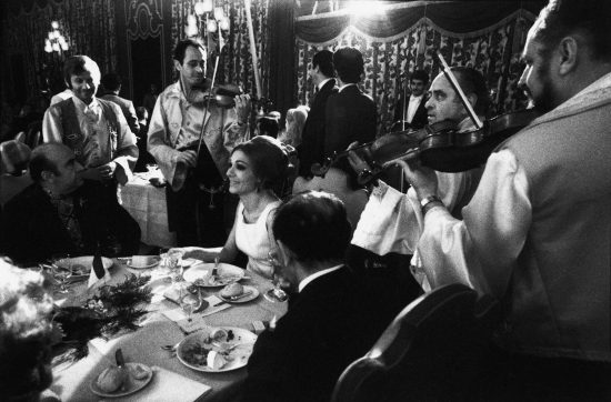 IRAN. Persepolis. Queen FARAH is serenaded during fund raising dinner for the French Charity "Le Bal des Petits Lits Blancs". On her right is Prime Minister Amir Abbas HOVEYDA, on her left Court Minister Assadollah ALAM. 1971.