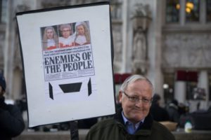 A man holds a placard featuring the front page of a national newspaper critical of the judges at the Supreme court outside the Supreme court in London on the first day of a four-day hearing on December 5, 2016. The government of Prime Minister Theresa May will today seek to overturn a ruling that it must obtain parliamentary approval before triggering Brexit, in a highly-charged case in Britain's highest court. / AFP / DANIEL LEAL-OLIVAS (Photo credit should read DANIEL LEAL-OLIVAS/AFP/Getty Images)